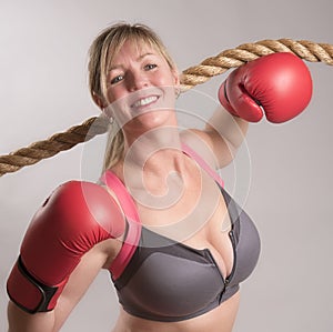 Boxer wearing sports bra with red gloves