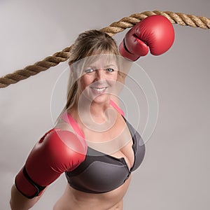 Boxer wearing sports bra with red gloves