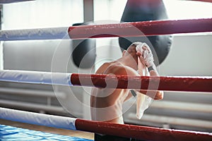 Boxer wiping the sweat after hard fight