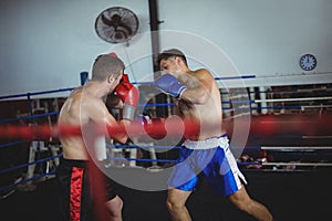 Boxers fighting in boxing ring