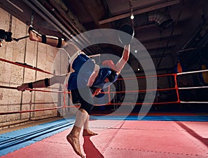 Boxers training kickboxing in the ring at the health club