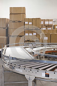 Boxes And Conveyor Belt In Warehouse