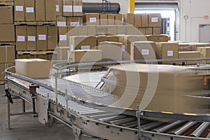 Boxes On Conveyor Belt In Warehouse photo