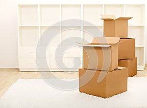 Boxes in front of empty shelves - moving concept