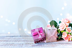 Boxes with gifts, a bouquet of flowers on a light blue background with bokeh. Women`s Day, Mother`s Day Concept