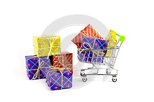 Boxes with gifts in bright packaging and shopping cart, preparation for the holidays, shopping
