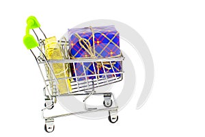 Boxes with gifts in bright packaging and shopping cart, preparation for the holidays, shopping
