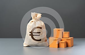 Boxes with goods and euro money bag. Import and export. Taxes. Revenues to the budget. Production of products. Economics and