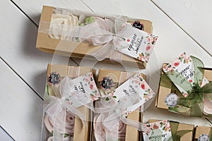 Boxes with homemade marshmallows. Tied with tape. The branded tag of the entrepreneur is visible. Zephyr flowers. Roses from