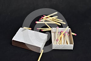 boxes and matches lie on a black background