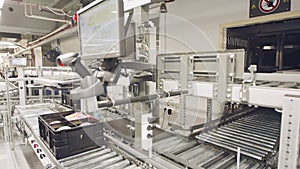 Boxes moving on conveyors in a large automated warehouse