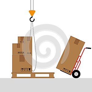Boxes on a pallet are lifted with a crane hook.