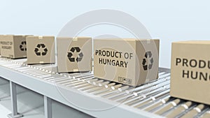 Boxes with PRODUCT OF HUNGARY text on roller conveyor. Hungarian import or export related 3D rendering