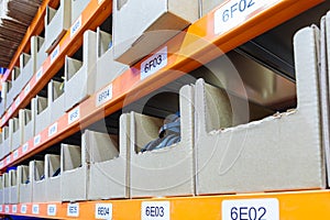 Boxes on racks in a warehouse of goods close-up.
