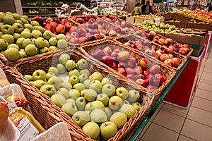 Boxes of red and green apples on boxes in shopping mall