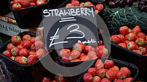 Boxes of strawberries sell in the market