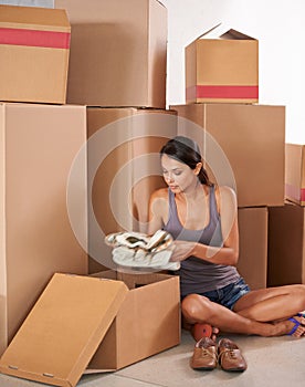 Boxes, young woman and unpacking for new house or package delivery for logistics and client unwrapping for move. Freight