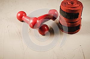 Boxing concept with red dumbbells and bandage/boxing concept with red dumbbells and bandage on a stone background