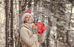 Boxing day. Girl celebrate Christmas. Winter holidays concept. Winter gift. Woman warm clothes snowy forest. December