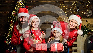 Boxing day. Happy holidays. Father bearded man and mother with cute daughters christmas tree background. Spend time with