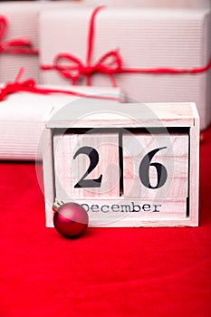 Boxing Day Sale. Calendar with date on red background. Christmas concept. December 26. Christmas ball and gifts