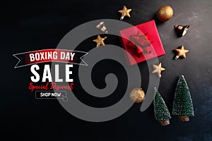 Boxing day sale with Christmas present and xmas decoration on black background