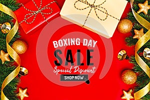 Boxing day sale with Christmas present and xmas decoration on red background