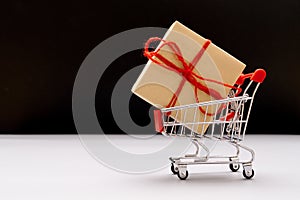 Boxing day sale, shopping cart and gift box with copy space