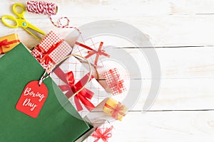 Boxing day Sale text on a black tag with shopping bag and gift box on a wooden white background. Online Shopping