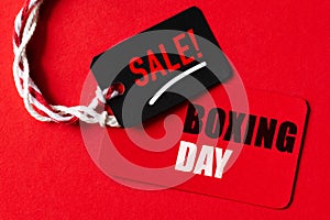 Boxing day Sale text on a red and black tag. Shopping