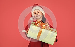 Boxing day. Small adorable girl Santa hat hold gift box. Kid hold present box red background. Merry Christmas and happy