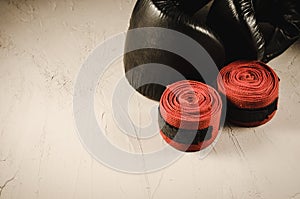 Boxing gloves and bandage/sport concept with black boxing gloves and red bandage. Selective focus and copyspace