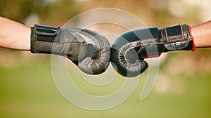 Boxing, gloves and fist bump with a boxer team outdoor together for sportsmanship, unity or solidarity. Sports, teamwork