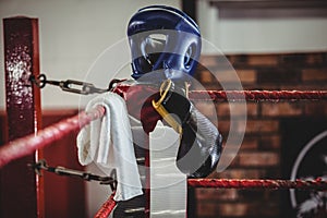 Boxing gloves, headgear and a towel kept on boxing ring