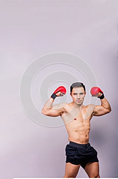 Boxing gloves, man training in sports fight, challenge or mma competition on studio background.