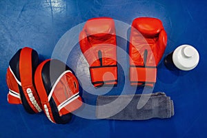 Boxing gloves, pads and equipment on ring, nobody