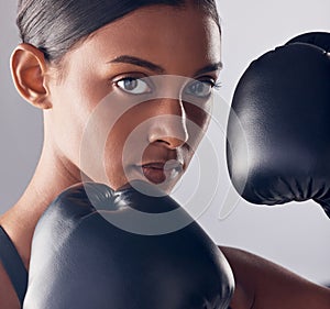 Boxing, gloves and portrait face of woman in studio for exercise, strong focus or mma training. Female boxer, workout