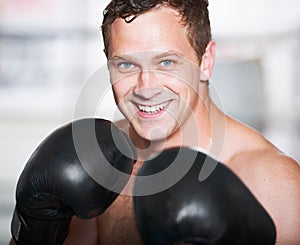 Boxing, gloves and portrait of happy man with fitness, power and training for challenge in gym. Strong body, muscle and