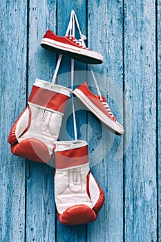 Boxing gloves and shoes hanging on the wall