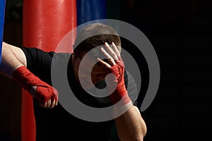 Boxing man holding head in pain