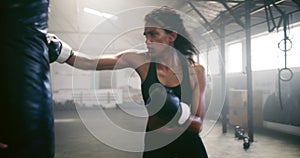 Boxing, personal trainer and fight with woman in gym for martial arts, workout and strong. Focus, health and cardio with