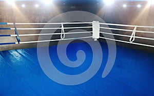 Boxing ring with blue flooring and white ropes