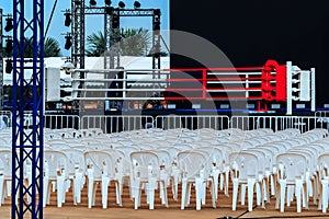 Boxing ring and many chairs for spectators prepared for competition, Outdoors. Sport and empty boxing ring in the city for a