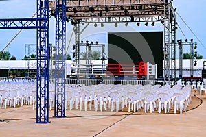 Boxing ring and many chairs for spectators prepared for competition, Outdoors. Sport and empty boxing ring in the city for a