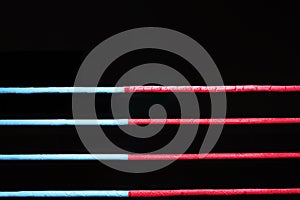 Boxing ring ropes on a black background. The concept of sports, mixed martial arts