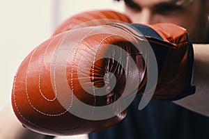 Boxing and sports concept. Athlete with leather box equipment isolated on white background