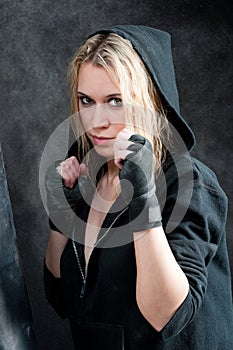 Boxing training woman in black grunge background