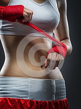 Boxing woman binds the bandage on his hand, before training, detail photo