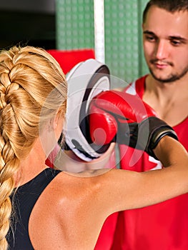 Boxing workout woman in fitness class. Sport exercise two people.