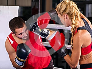 Boxing workout woman in fitness class. Sport exercise two people.